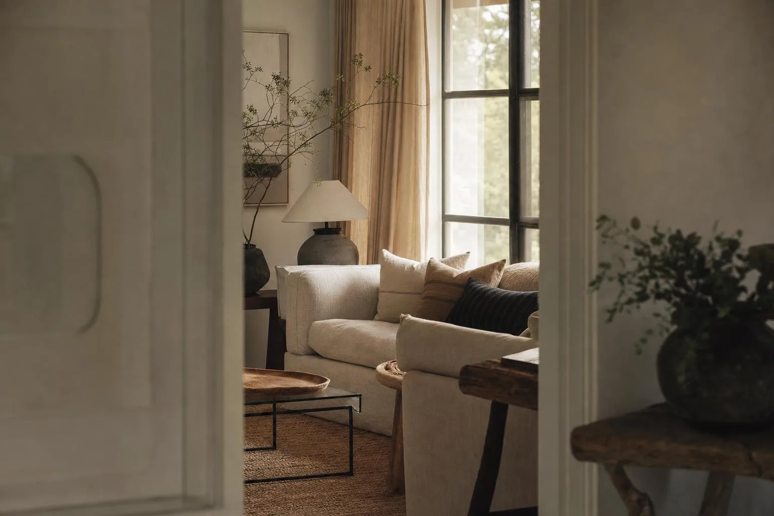 Warm minimal interior in taupe, cream and oak with soft daylight